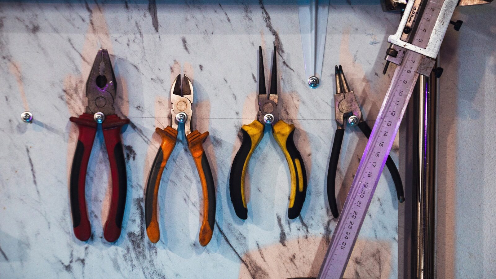 A bunch of tools hanging on a wall